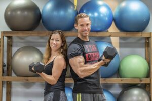 a man and woman lifting weights